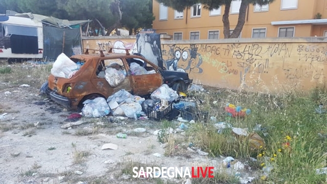 ‘Scheletri’ d’auto e bustoni colmi di rifiuti, benvenuti a Is Mirrionis. Le foto